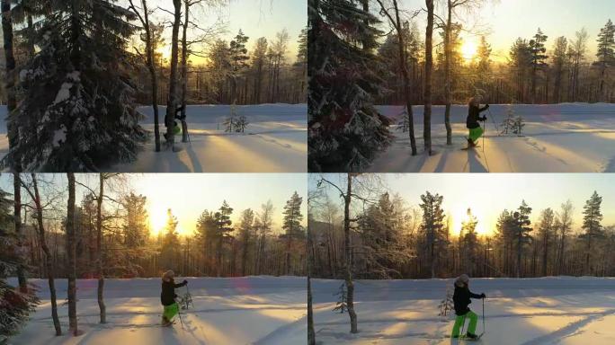 金色冬季日落时，空中微笑女孩雪鞋在深雪表面徒步旅行