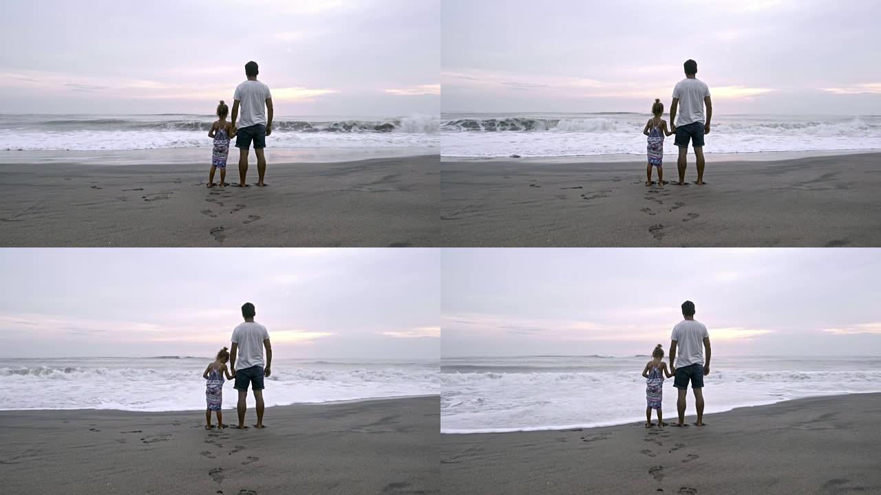 小女孩和爸爸一起看海洋日出