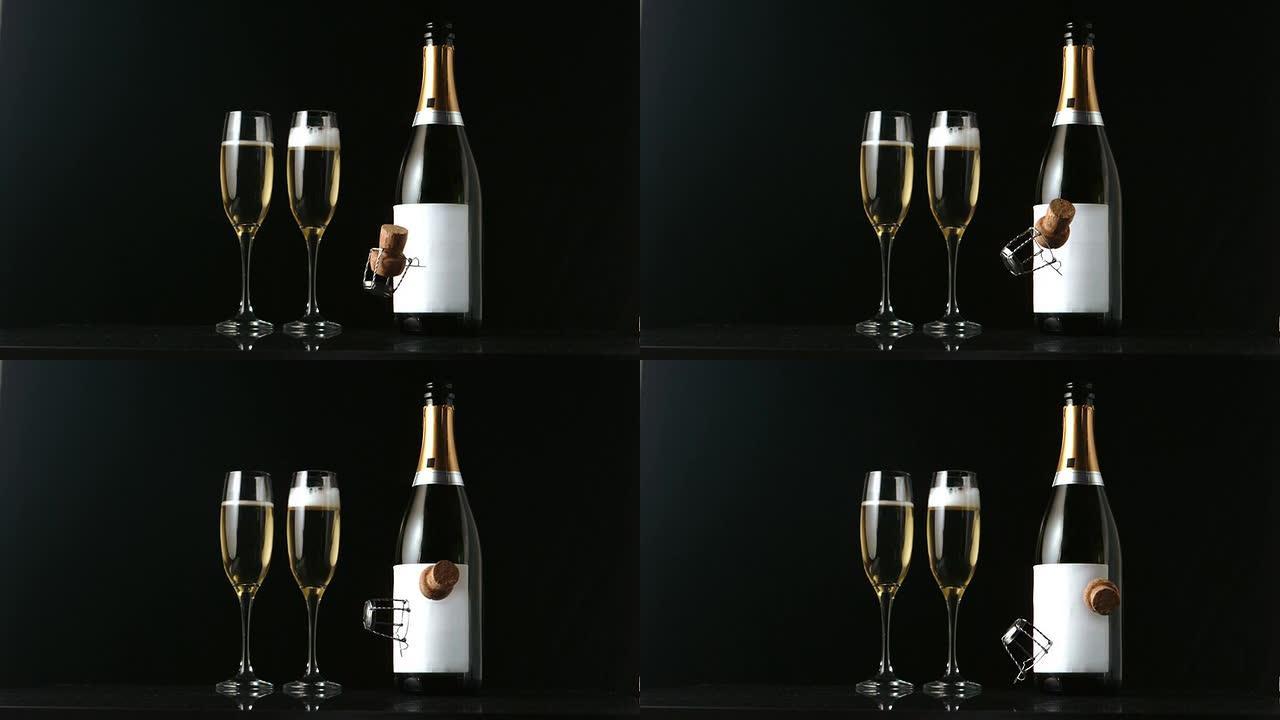 香槟软木塞落在两个长笛和瓶子的前面