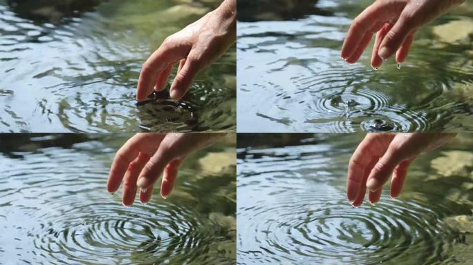 慢动作特写: 水滴从湿手指上滴下来