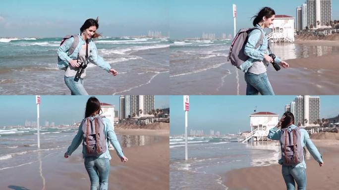 美丽的高加索女孩在海滩上从海浪中奔跑。漂亮的女人对着镜头微笑。风吹进头发。慢动作