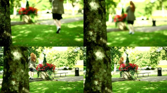 可爱的女人走过绿色公园