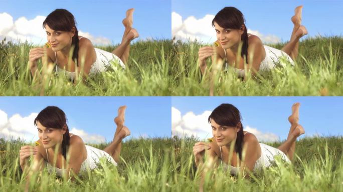 高清慢动作: 一个躺在草地上的女人的肖像