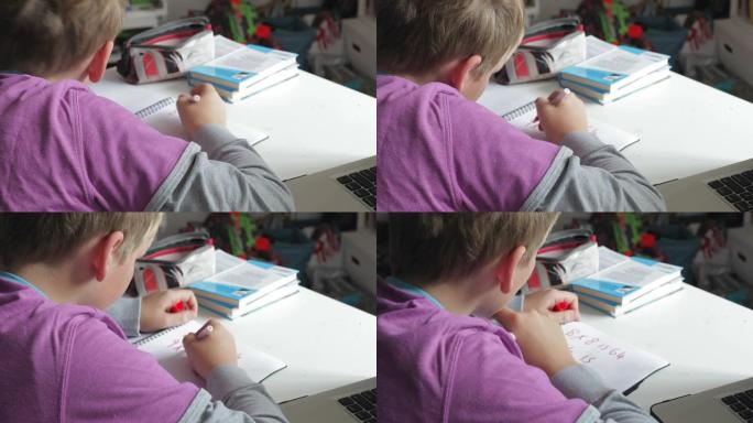 男孩在卧室做数学作业