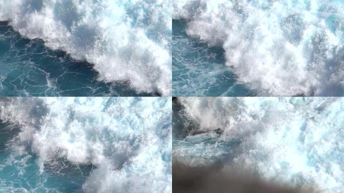 慢动作大桶状泡沫海浪坠入海滩上的岩石礁