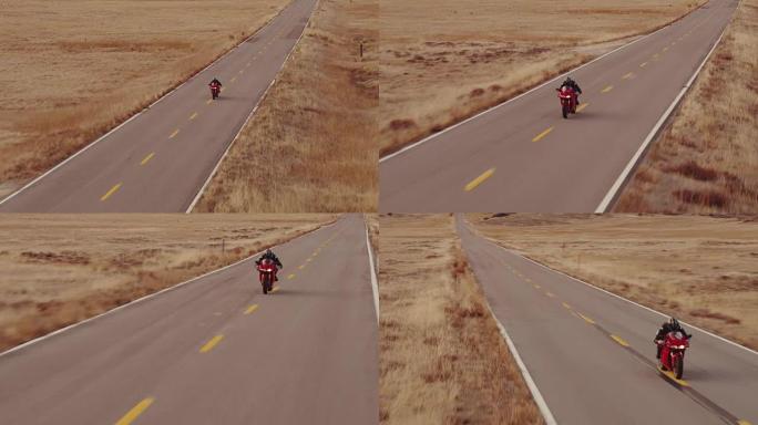 极端男子在日落时在直道公路上驾驶摩托车的航拍