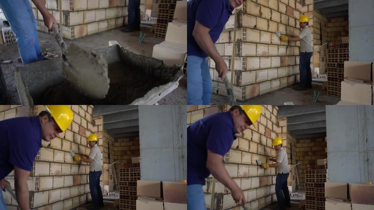 建筑工地的建筑工人正在搅拌水泥并用铁锹建造砖墙