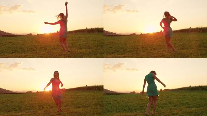 慢动作: 放松的年轻女子在日出时在美丽的草地上自由跳舞。