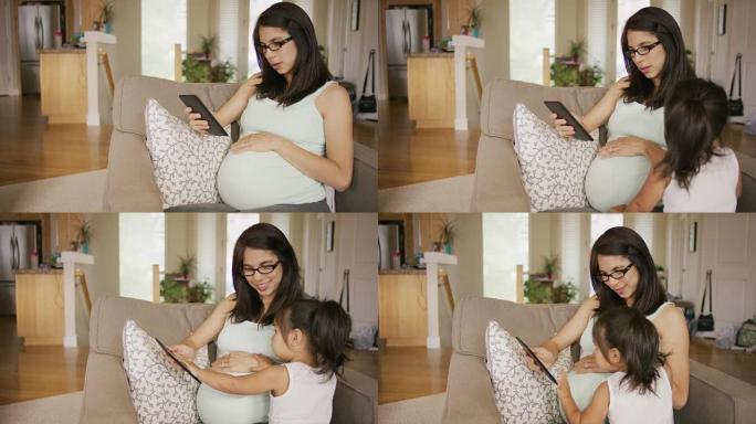 年轻的孕妇使用平板电脑