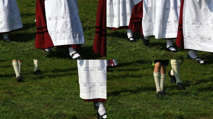 穿着传统服装的巴伐利亚人在牧场上行走