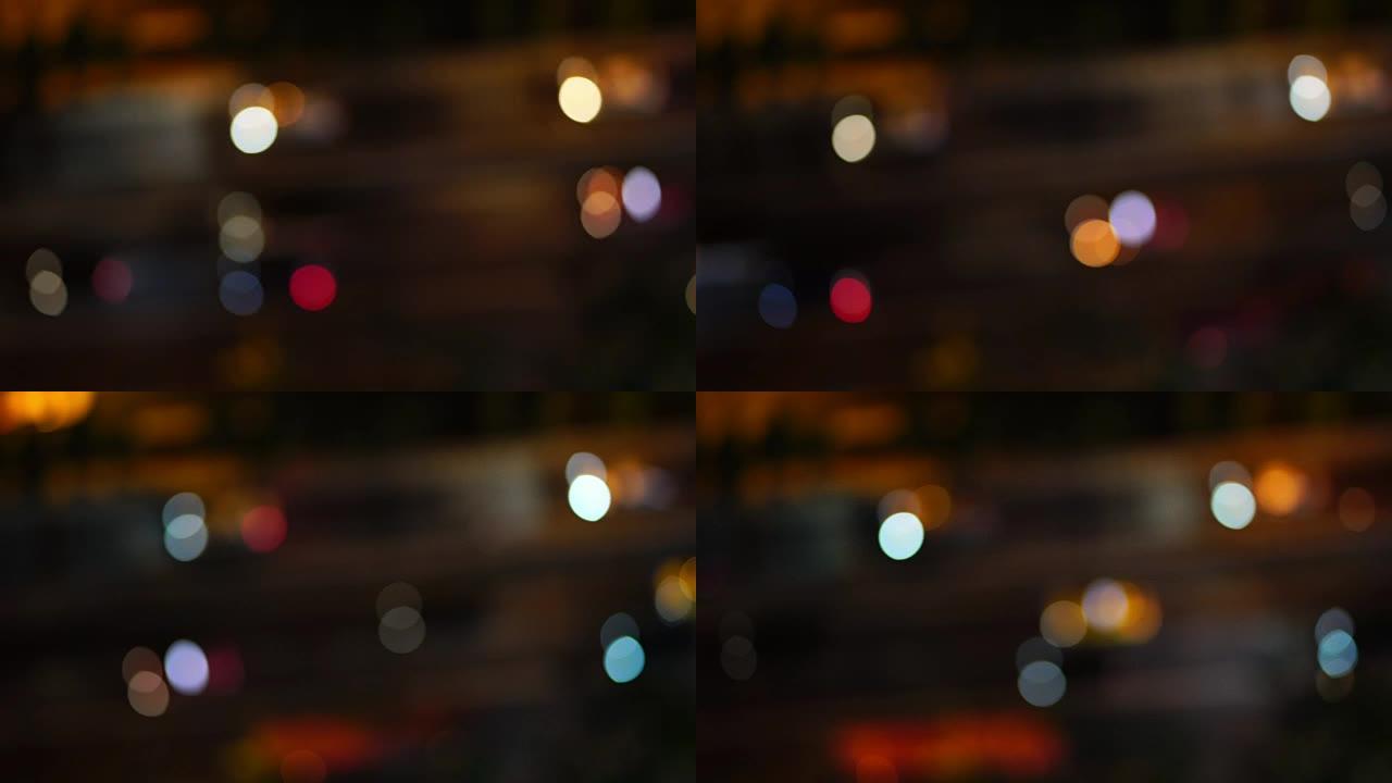 4k镜头，从顶部看，从汽车上看，道路上的交通模糊散焦光，夜间从汽车上看