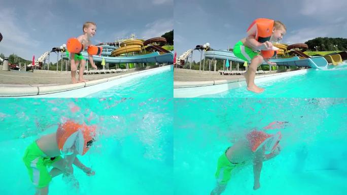 水下慢动作: 小快乐的孩子跳入水中