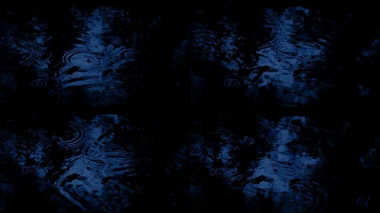 黑暗中森林游泳池上的雨滴