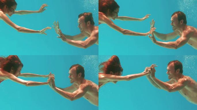 快乐的情侣在水下游泳