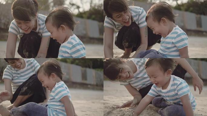 年轻的母亲和她的儿子在海滩上玩耍