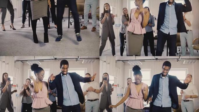 两个非裔美国同事在办公室聚会上跳舞。混合种族朋友在工作场所4K有趣的活动