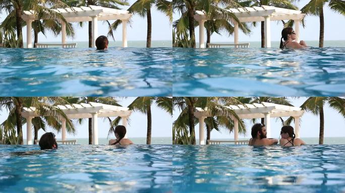 女子在热带度假区的无限泳池游泳