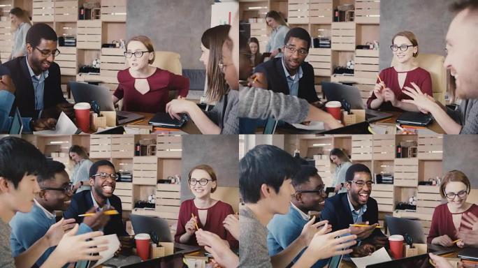 多民族团队致力于新的项目构想。快乐的办公室同事在头脑风暴商务会议上微笑。4K