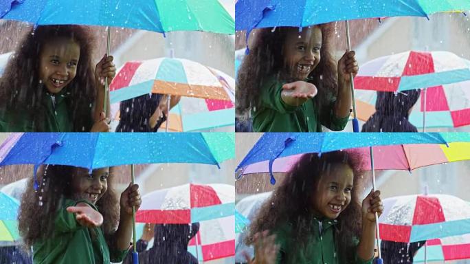 笑着的小女孩捕捉雨滴