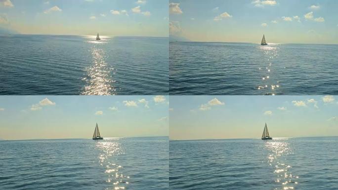 4k空中无人机视点帆船在宁静、阳光明媚的蓝色海洋上，实时