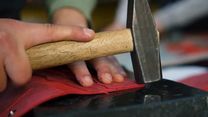 工匠用锤子连接皮革边缘