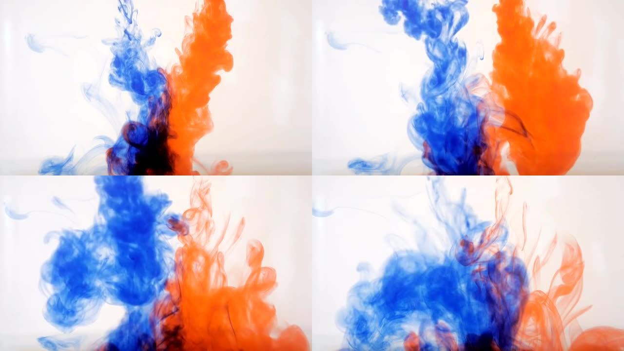 彩色背景。蓝色和红色墨水掉进了水里。慢动作