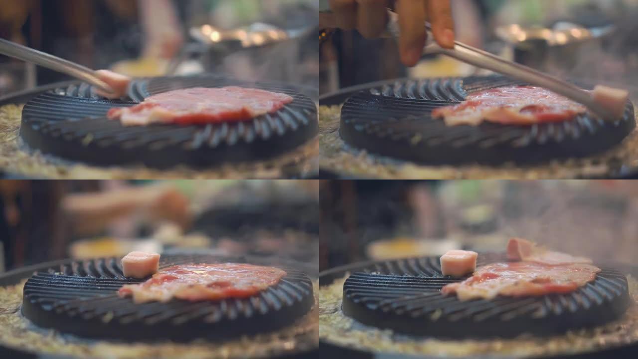 烹饪烧烤，在炉子上用木炭烧烤。关闭日本餐厅烤牛肉。烧烤或日式食品用生牛肉片