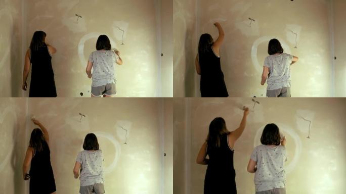 妇女在墙上画白色圆圈，慢动作