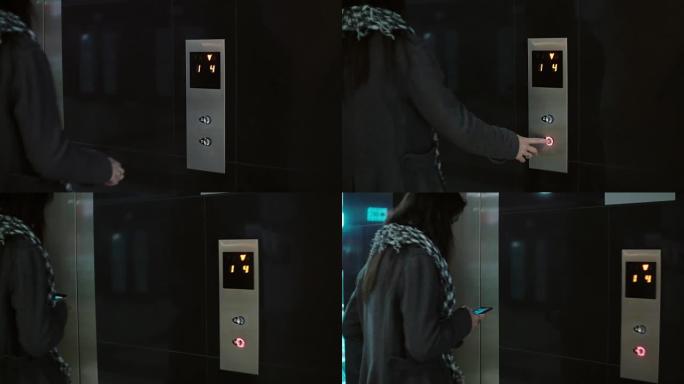 戴围巾的女人按下电梯里的按钮。女性站在办公室并使用智能手机