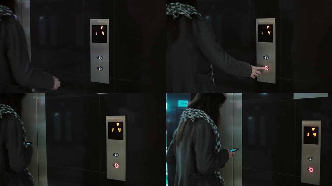 戴围巾的女人按下电梯里的按钮。女性站在办公室并使用智能手机