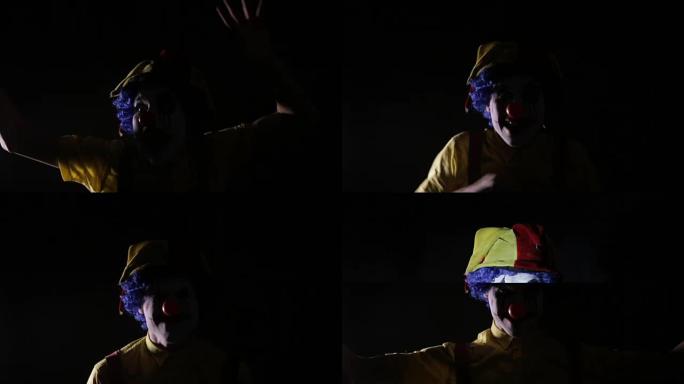 恐怖的镜头，一个怪异的疯狂小丑在频闪仪下的黑暗房间里做着令人恐惧的面孔。肖像