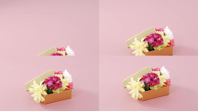 粉色背景下充满花朵的礼品盒