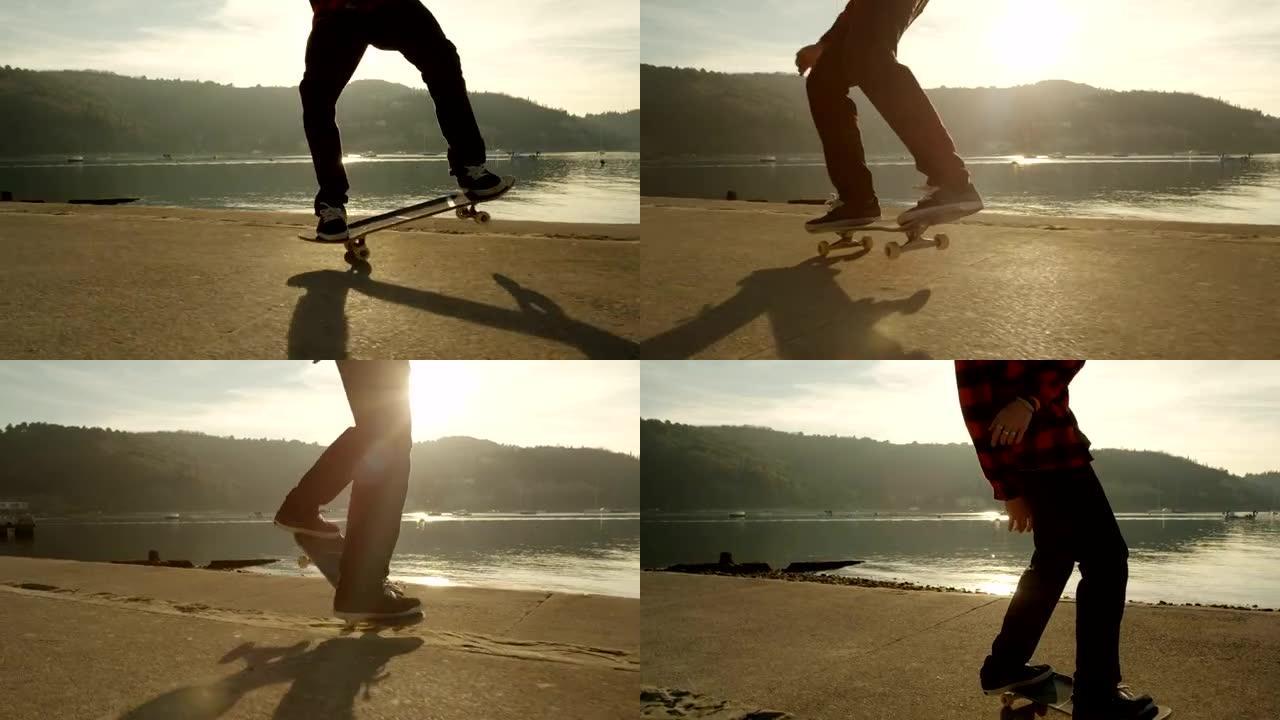 慢动作特写: 滑板手在日落时在海滩上跳ollie花样