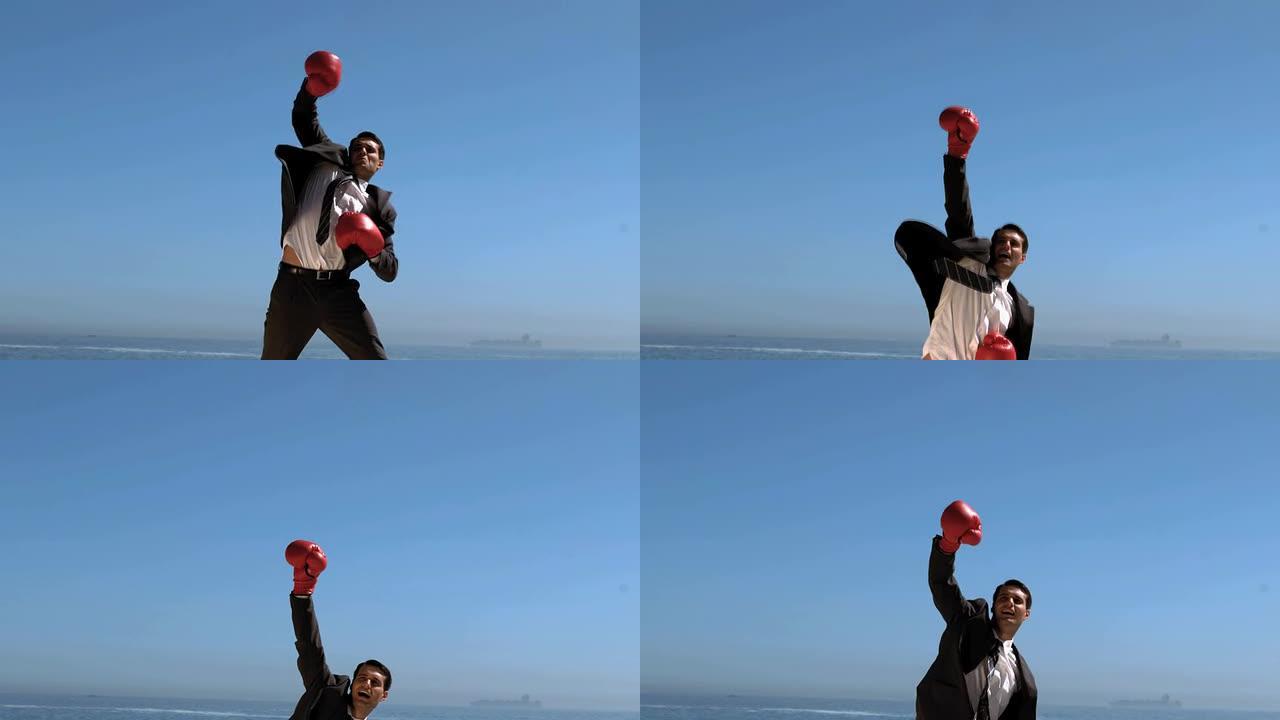 戴着红色拳击手套的迷人商人跳跃