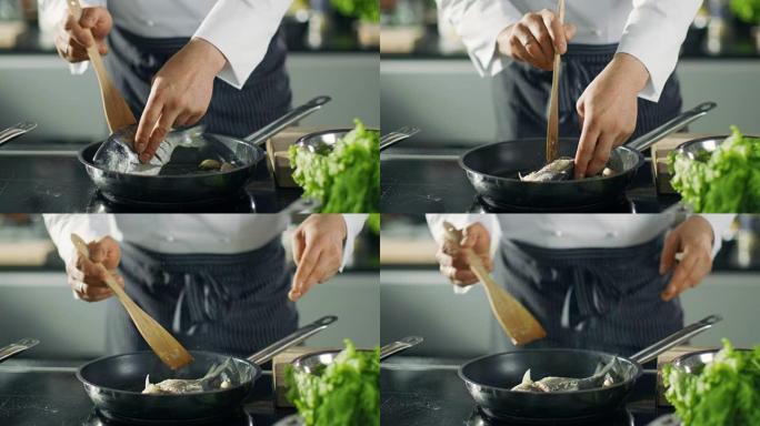 著名的餐厅厨师在热锅上翻鱼。看到风景如画的蔬菜的平底锅特写镜头。