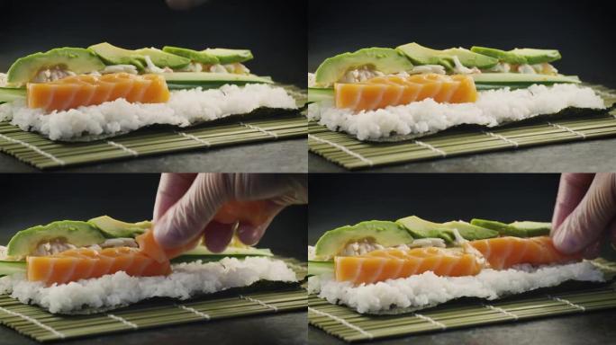 专业厨师在日本餐厅准备三文鱼和鳄梨寿司卷