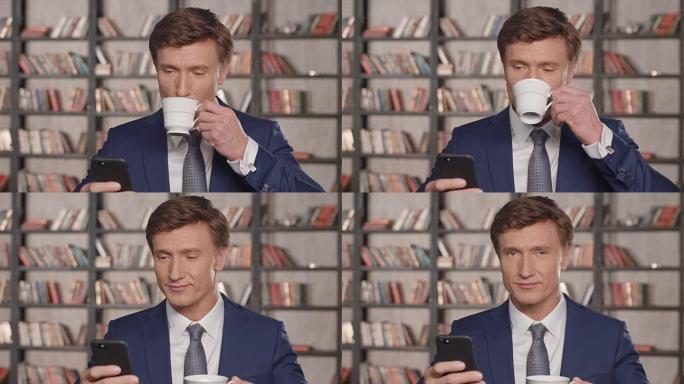 成功的有吸引力的商人使用智能手机应用程序和在办公室微笑喝茶的慢动作肖像。商人系列。