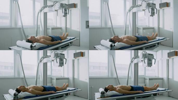 在医院，男子在x光机扫描过程中躺在床上。扫描骨折，四肢骨折，损伤，癌症或肿瘤。拥有技术先进的医疗设备