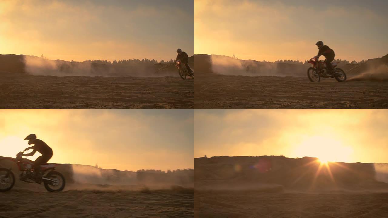 职业摩托车越野赛车手在越野沙地上骑着他的FMX摩托车。夕阳西下，薄雾笼罩大地。