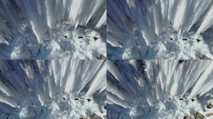 空中: 在冬季山崖上飞起令人惊叹的冰冻瀑布冰柱