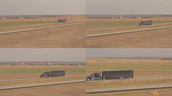 天线: 货运集装箱半卡车沿着高速公路驶过农田