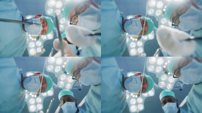 低角度镜头视点患者视图: 三名专业外科医生拿着手术器械开始手术。