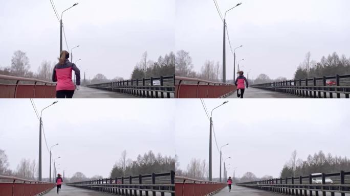 寒冷天气下在桥上跑步的女运动员