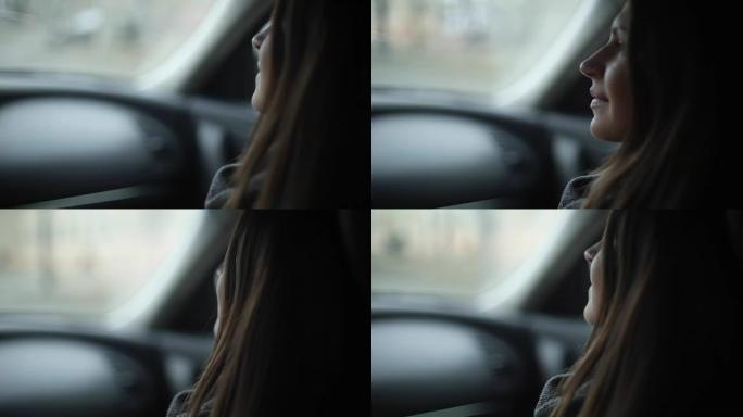 坐在车里的漂亮女孩。她握着司机的手，看着他和窗户。侧面和背面视图