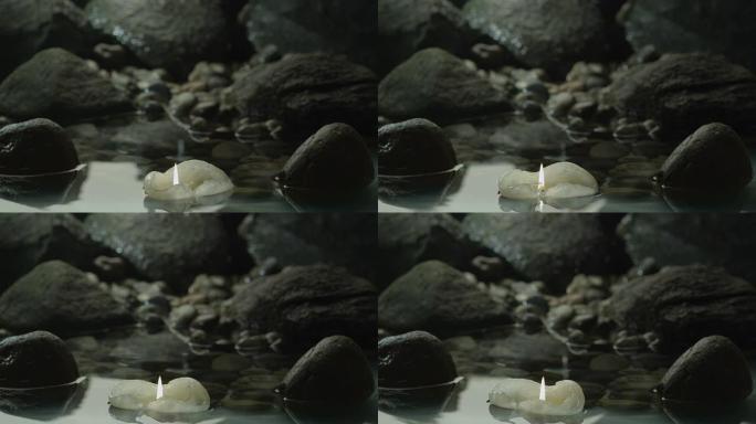 蜡烛漂浮在岩石之间
