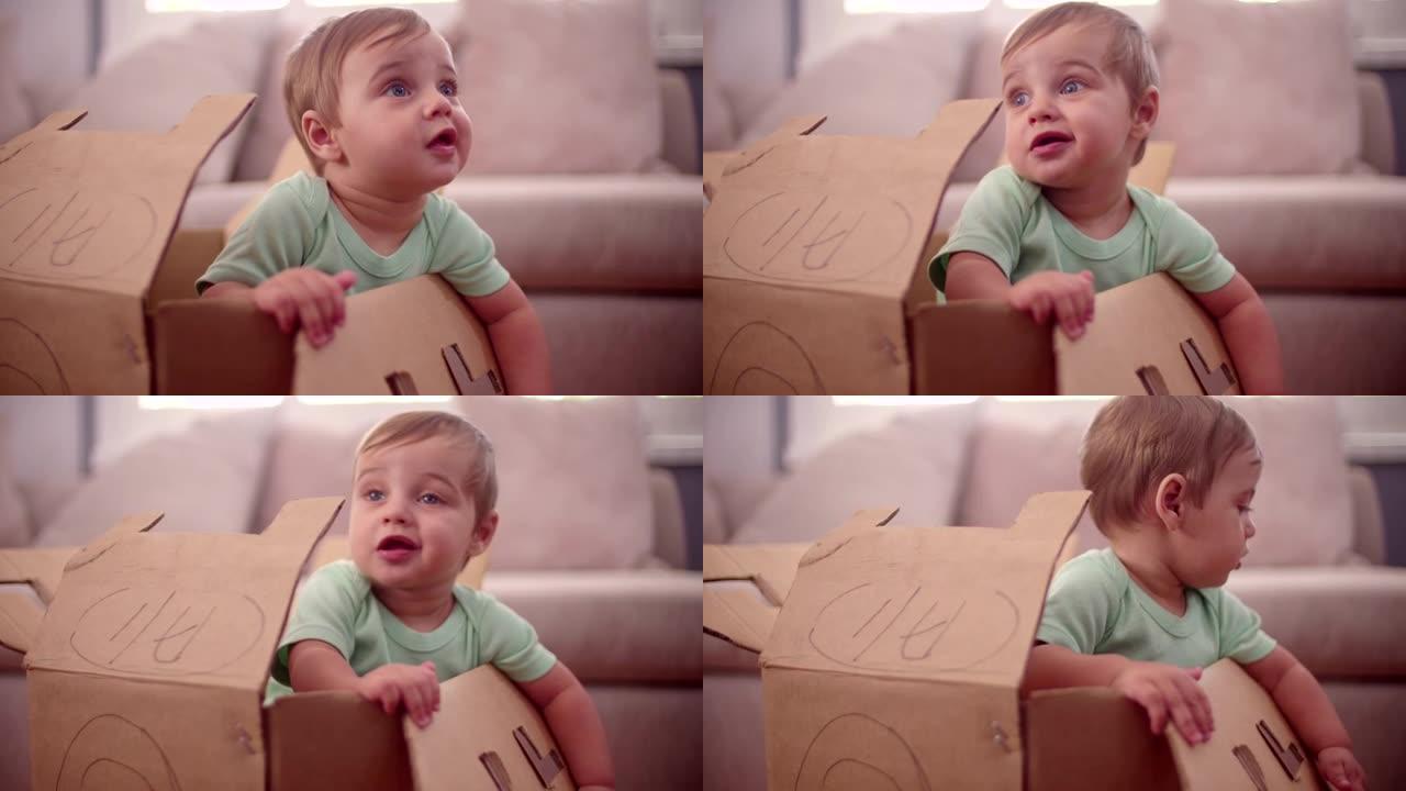 男婴在纸板箱里玩耍