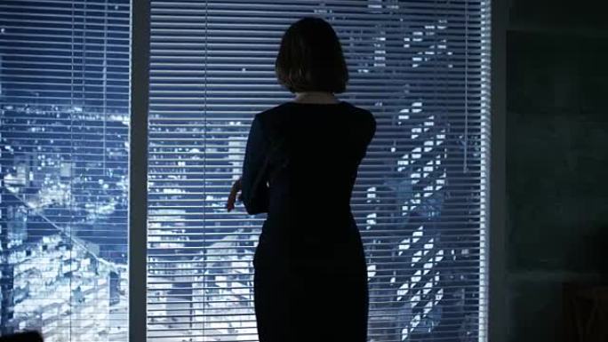 在一个现代的办公室女商人深思地看着窗外的大城市。
