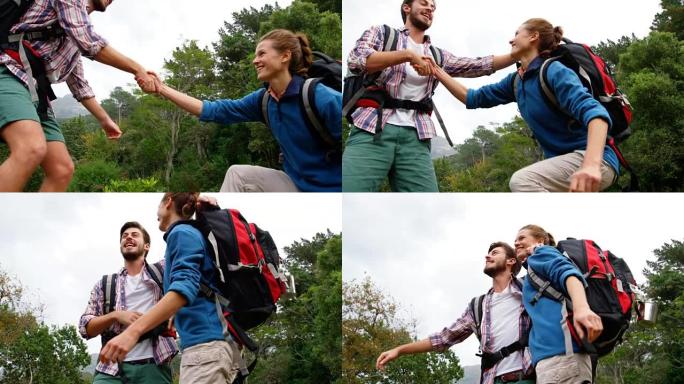 男人帮助女人男人帮助女人团队合作爬山背包