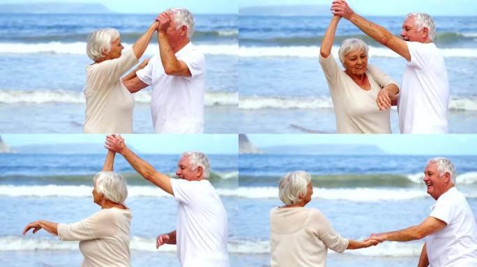 快乐的高级夫妇在沙滩上跳舞