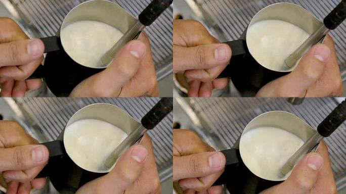4k咖啡师在水罐中准备牛奶作为咖啡。